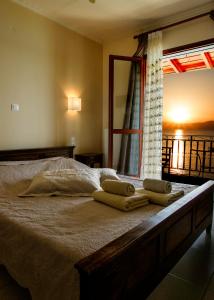 ein Schlafzimmer mit einem Bett mit Handtüchern darauf in der Unterkunft SAGA Pension in Gythio