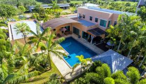 an aerial view of a house with a swimming pool at Tamali Hotel in Nakhon Si Thammarat