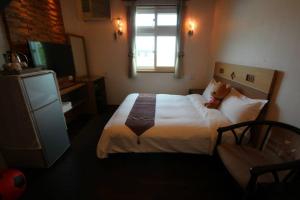 Postel nebo postele na pokoji v ubytování Mei Man Slide Homestay