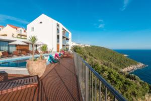 a balcony of a house with a pool and the ocean at Residence Delta in Cavtat