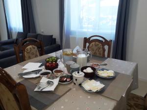 a table with plates of food on top of it at Chalet Pkhelshe in kazbegi in Kazbegi