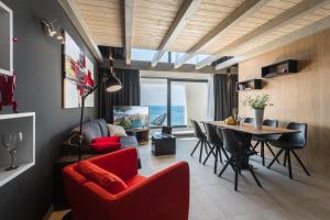 a living room with a red couch and a table at Residence Delta in Cavtat