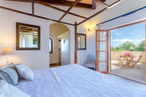 a bedroom with a large bed and a patio at Angigal in Manacor +44 photos