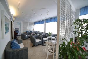 a living room with couches and chairs in a room at Hotel Villa Rosa in Sestri Levante