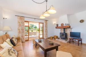 a living room with a couch and a fireplace at Angigal in Manacor