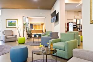 a living room with chairs and a table in a room at Hotel Grifone in Principina a Mare