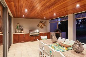a kitchen and dining room with a wooden ceiling at The Bay Residence, Dunsborough WA in Quindalup