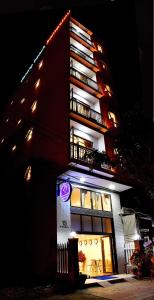 a tall building with lights on top of it at Danang Beach Homestay in Danang