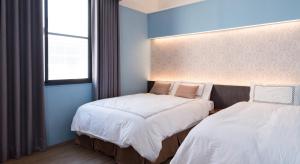 Tianli Hotel tesisinde bir odada yatak veya yataklar