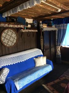 a bedroom with a blue and white bed in a boat at Karelskaya Usadba Hotel Complex in Shuya