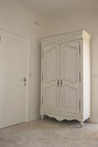 a white cabinet in a room with a door at Owl Barn in Kings Lynn