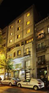 two cars parked in front of a building at Gallery Residence & Hotel Nişantaşı in Istanbul