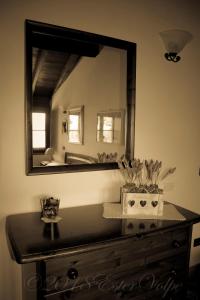 a mirror on top of a dresser in a room at Bed & Breakfast Ca' di Vissai in Arnasco