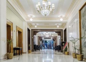 a hallway of a building with a chandelier at Grand Uniara A Heritage Hotel in Jaipur +140 photos