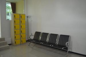 a row of empty chairs in a waiting room at Huize Jon Hostel in Malang