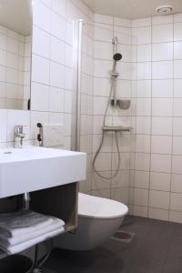 a bathroom with a toilet and a sink and a shower at GreenStar Hotel Jyväskylä in Jyväskylä +17 photos