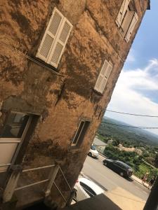 an old building with a view of a city at A Balamata in Cervione