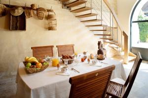 a table with a basket of fruit on it at L'Hote Antique - MAISON D'HOTE- 4 Suites avec cuisine in Pichanges