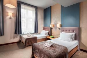 Posteľ alebo postele v izbe v ubytovaní Hotel Unicus Krakow Old Town - Destigo Hotels