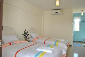 Postel nebo postele na pokoji v ubytování O.U.M. Hotel - โรงแรมโอยูเอ็ม