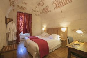 Säng eller sängar i ett rum på Les Chambres de l'Abbaye