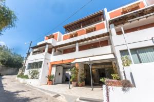 a white building with orange accents at Residence Hotel Baia Portinenti in Lipari