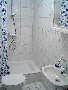 y baño con ducha, aseo y lavamanos. en Lakeside Bed and Breakfast Berlin - Pension Am See en Falkensee