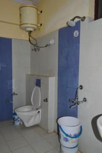 a bathroom with a toilet and a sink at Hotel Auli D in Joshīmath