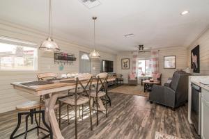 a kitchen and living room with a table and chairs at Serenity By The Sea Cottage A in Clearwater Beach