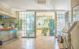 a entrance to a restaurant with a glass door at Loule Jardim Hotel in Loulé