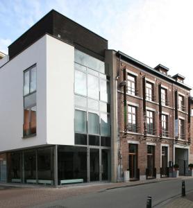 an office building with glass windows on a street at Hotel De Groene Hendrickx in Hasselt