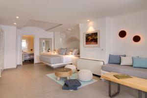 a living room with a couch and a bed at Secret Legend Suites in Oia