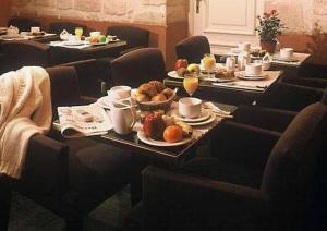 a table with plates of food on it in a restaurant at Victoires Opera in Paris