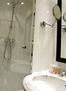 a bathroom with a shower and a sink at Victoires Opera in Paris