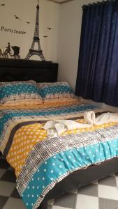 a bed in a bedroom with the eiffel tower at La Casa De Huespedes in Bogotá