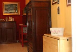 a room with a large wooden cabinet with a white bowl at Casa Vacanza Da Andrea in Naples