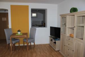 a living room filled with furniture and a tv at APARTHOTEL 1A in Zwickau
