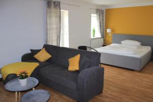 a living room with a couch and a bed at APARTHOTEL 1A in Zwickau