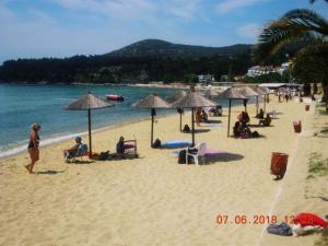 a group of people on a beach with umbrellas at Giorgos-Vera in Kavála