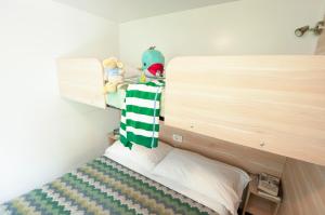 a stuffed animal on top of a bed in a room at Camping Serenissima in Malcontenta