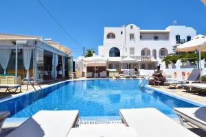 a pool at a hotel with white buildings at Rodakas Hotel in Akrotiri