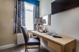 a home office with a desk and a chair at The Golden Lion Hotel, St Ives, Cambridgeshire in St. Ives