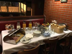 a table in a restaurant with a white table cloth at Firmhotel le 37 in Firminy