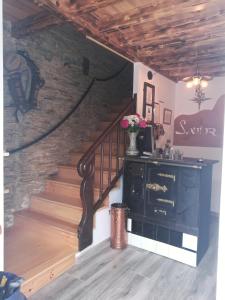 a staircase in a room with a fireplace and a stair case at Albergue Savior in Lourenzá