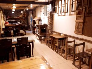 a restaurant with wooden tables and chairs in a room at SuWaNa in Leye