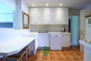 a kitchen with white cabinets and a sink at Marla by Smiling Rentals in Hondarribia