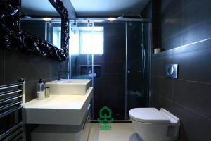a bathroom with a toilet and a sink and a shower at Marla by Smiling Rentals in Hondarribia