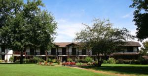 a large house with a lawn and trees at Auberge des Pins - Teritoria in Sabres