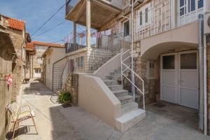 a staircase leading up to a building with a door at Apartments Mate in Komiža