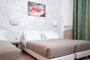 Posteľ alebo postele v izbe v ubytovaní Hotel Columbia